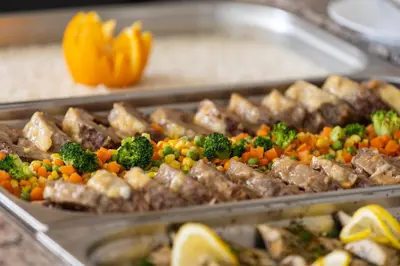 a tray of food with meat and vegetables on at Hotel Azurro - All Inclusive in Sunny Beach