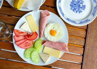 a plate of food with eggs cheese and fruit at Family Hotel Jemelly in Obzor