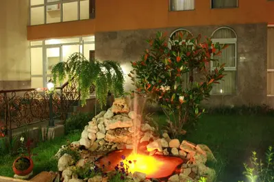 a garden with a fire pit in the yard at Hotel Princess Residence in Kiten