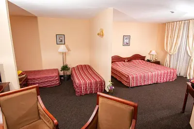 a hotel room with two beds and two chairs at Hotel Princess Residence in Kiten