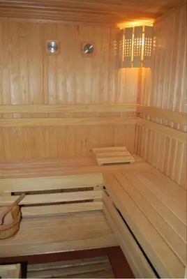 a sauna with wooden paneled walls and a wooden floor at Italia Hotel in Nesebar