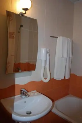 a bathroom with a sink and a mirror at Italia Hotel in Nesebar