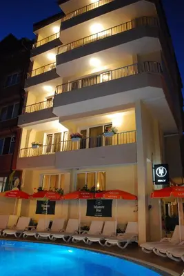 a hotel with a swimming pool in front of a building at Italia Hotel in Nesebar