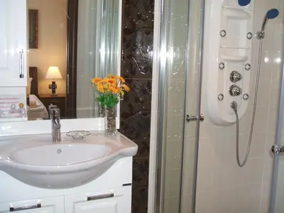 a bathroom with a sink and a shower at Laguna Beach Resort & Spa in Sozopol