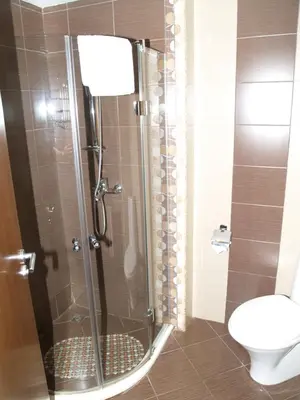 a bathroom with a glass shower with a toilet at Laguna Beach Resort & Spa in Sozopol