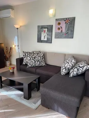 a living room with a couch and a coffee table at Apartament Ivanovi A119 in Burgas City