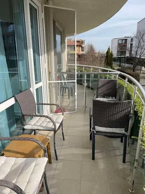 a balcony with chairs and tables on a building at Apartament Ivanovi A119 in Burgas City