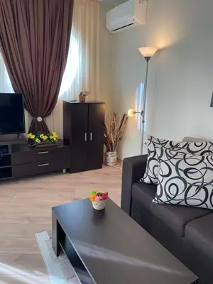 a living room with a couch and a coffee table at Apartament Ivanovi A119 in Burgas City