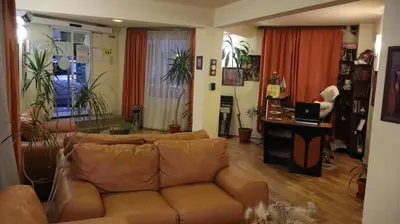 a living room with a brown leather couch at Hotel Palitra in Varna City