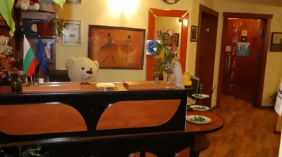 a stuffed teddy bear sitting on top of a table at Hotel Palitra in Varna City
