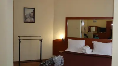 a bedroom with a bed with a large mirror at Hotel Palitra in Varna City