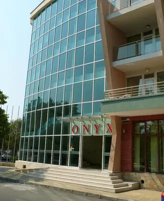 an office building with a sign that reads only at Hotel Onyx in Kiten