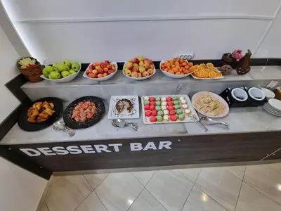 a dessert bar with different types of food on a table at Aquamarine Hotel - All Inclusive in Sunny Beach