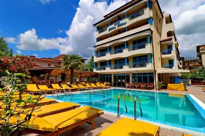 a hotel with a swimming pool with yellow lounge chairs at Bora Bora Hotel in Sunny Beach