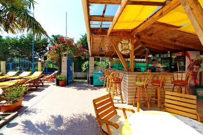 a patio with tables and chairs and a restaurant at Bora Bora Hotel in Sunny Beach