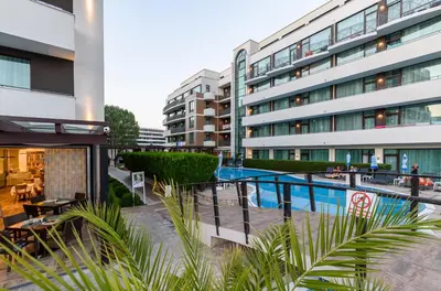 an external view of a building with a swimming pool at Lion Sunny Beach Hotel in Sunny Beach