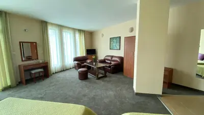 a living room with leather chairs and a table at Hotel L&B- Free parking in Sunny Beach