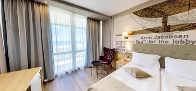 a hotel room with a bed and a desk at Effect Grand Victoria Hotel - Ultra All Inclusive in Sunny Beach