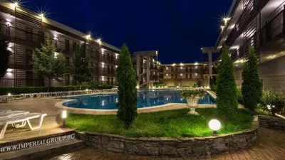 a hotel courtyard with a pool at night at HI Hotels Imperial Resort - Ultra All Inclusive, FREE PARKING in Sunny Beach