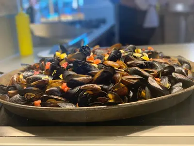 a pile of mussels in a pan on a counter at HI Hotels Imperial Resort - Ultra All Inclusive, FREE PARKING in Sunny Beach