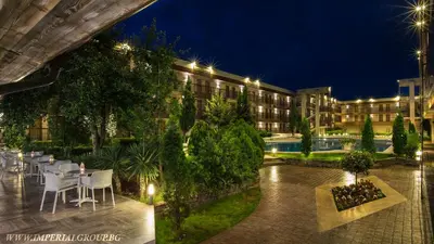 a hotel with tables and chairs in front of a building at HI Hotels Imperial Resort - Ultra All Inclusive, FREE PARKING in Sunny Beach