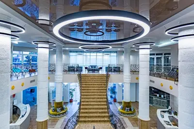 a staircase in a building with columns and a chandelier at HI Hotels Imperial Resort - Ultra All Inclusive, FREE PARKING in Sunny Beach
