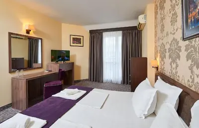 a hotel room with a bed and a television at Sunny Beach Hotel Forum - All Inclusive in Sunny Beach