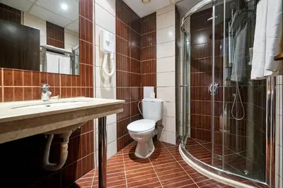 a bathroom with a toilet and a shower and a sink at Sunny Beach Hotel Forum - All Inclusive in Sunny Beach