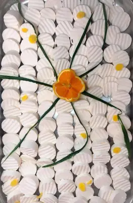 a cake with an orange flower on top of it at Flamingo Hotel Sunny Beach in Sunny Beach