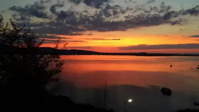 a sunset over a large body of water at ORION Guest House in Sozopol