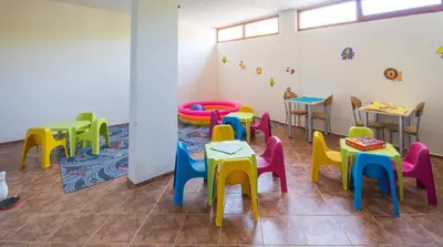 a room with brightly colored tables and chairs at Serena Residence Aparthotel in Sozopol