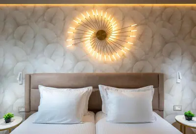 a bedroom with two beds and a mirror on the wall at Marieta Palace Hotel in Nesebar
