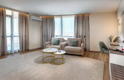 a living room with a couch and a table at Marieta Palace Hotel in Nesebar