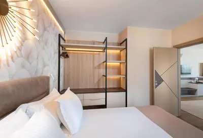 a bedroom with a bed and a closet at Marieta Palace Hotel in Nesebar