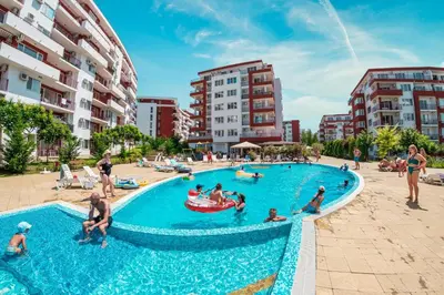 a group of people in a pool at a resort at Grand Resort in Sveti Vlas