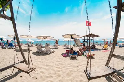 a group of people sitting in chairs on a beach at Grand Resort in Sveti Vlas