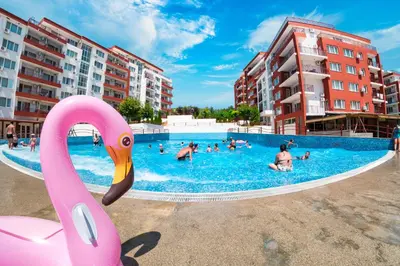 a swimming pool with a pink swan in the foreground at Grand Resort in Sveti Vlas