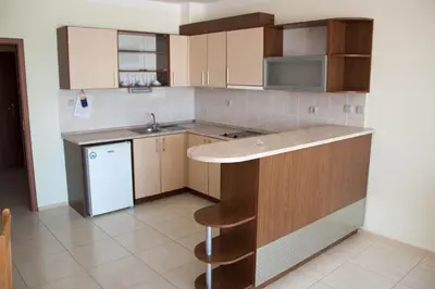an empty kitchen with a sink and a refrigerator at Gardenia Vacation Settlement in Sozopol