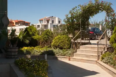 a set of stairs in a yard with flowers at Gardenia Vacation Settlement in Sozopol