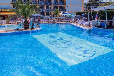 a large swimming pool with a sign in the water at Smartline Meridian Hotel in Sunny Beach