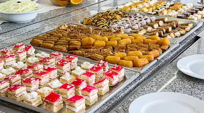 a buffet filled with different types of desserts and pastries at Smartline Meridian Hotel in Sunny Beach