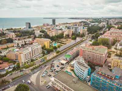 an aerial view of a city with buildings and the ocean at Hotel Bohemi in Sunny Beach