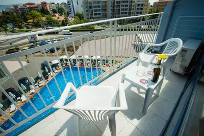 a balcony with a table and chairs and a pool at Hotel Bohemi in Sunny Beach