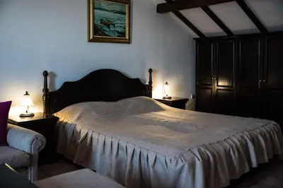 a bedroom with a large bed and two night stands at Victoria Hotel Nessebar in Nesebar