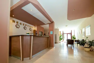 a hospital lobby with a reception desk and chairs at Apartment Tourist Complex Rose Village in Sunny Beach