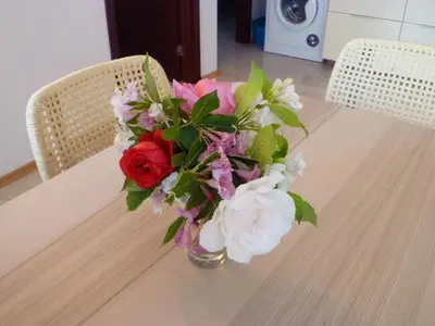 a vase of flowers sitting on a table at Apartment Tourist Complex Rose Village in Sunny Beach