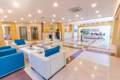 a lobby of a hospital with couches and tables at Bilyana Beach Hotel- Adults only in Nesebar