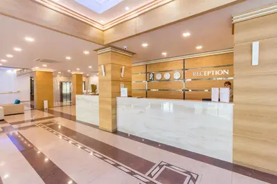a lobby with a reception desk in a building at Bilyana Beach Hotel- Adults only in Nesebar