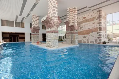 a swimming pool in a building with a large swimming pool at Bilyana Beach Hotel- Adults only in Nesebar
