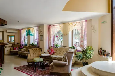 a living room with couches and chairs and windows at Hi Boutique Hotel in Varna City